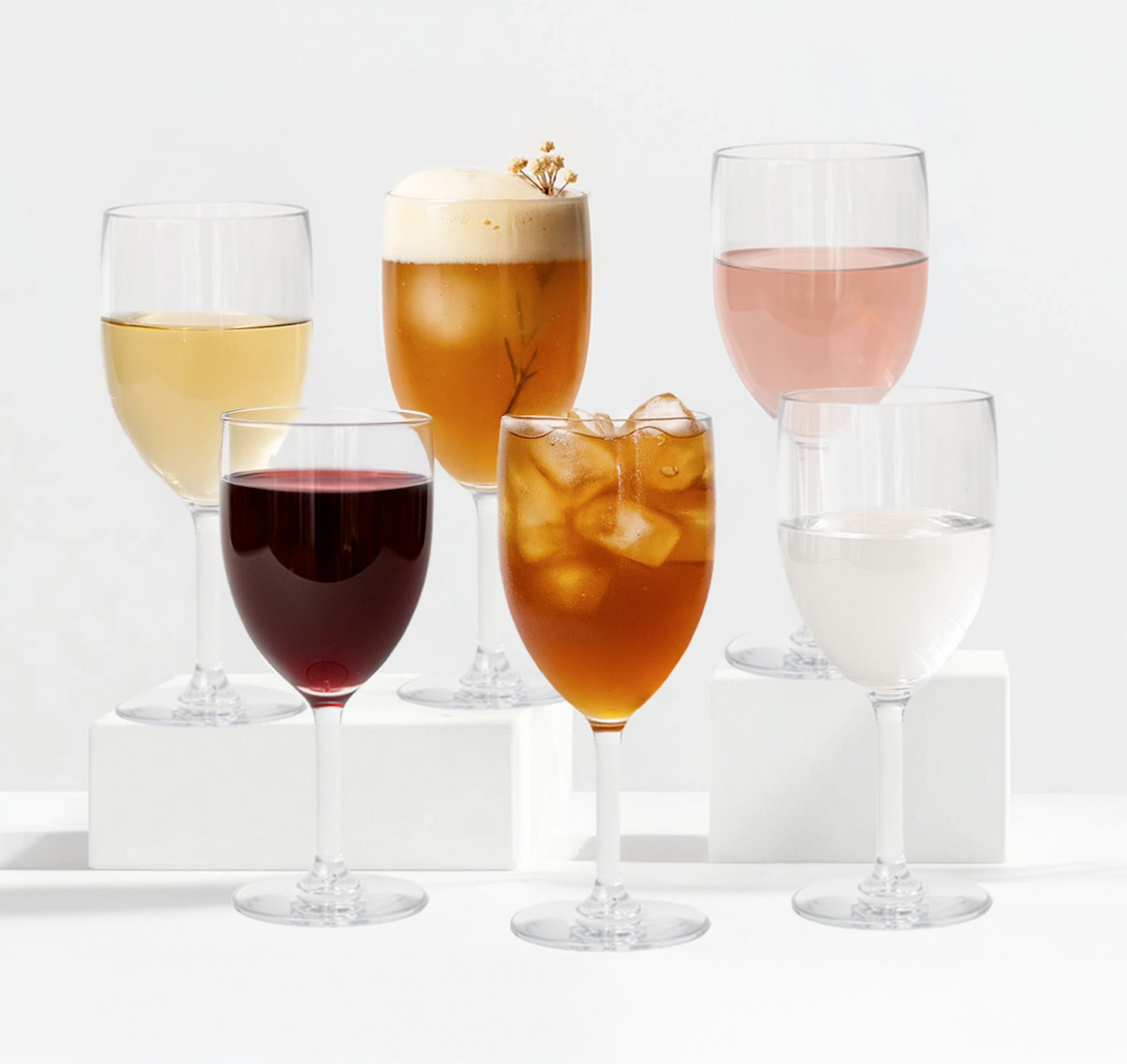 Collection of various glasses with different beverages on a white background