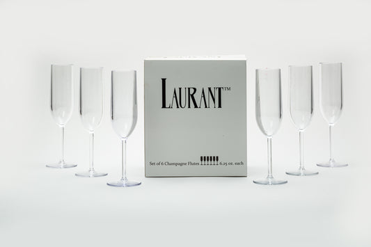 A set of six disposable champagne flutes placed eloquently next to their champagne flute packaging 
