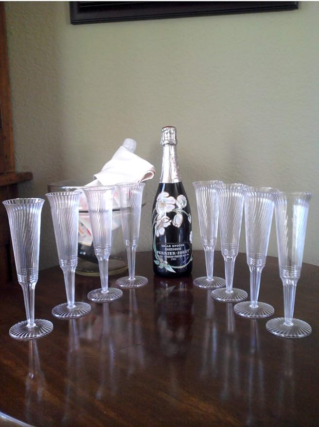 Bulk options for champagne glasses arranged in a V on the table with a champagne bottle at the center.  These are great for graduations and weddings