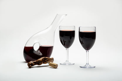 a carafe next to two disposable wine glasses, set in a classy disposable wine glass setting 