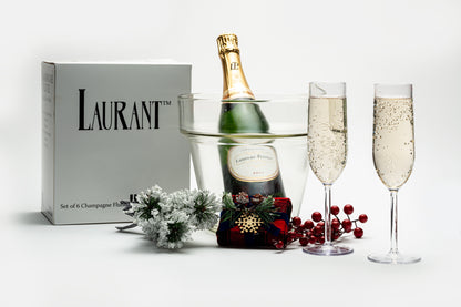 disposable champagne flutes next to their packaging adorn with a bottle of champagne and holiday decorations