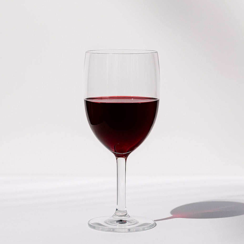 Laurant wine glass filled with red wine on a clean studio background